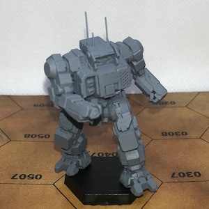 May include: A gray plastic model of a robot, standing on a hexagonal base. The robot has a boxy design with a large head and two arms. The robot is posed in a walking stance.