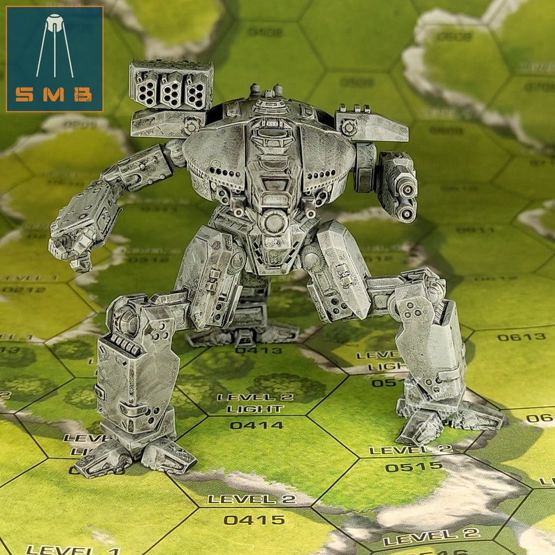 May include: A detailed, gray miniature robot with multiple weapons and a complex design. The robot is standing on a green and white hexagonal grid, with the letters "SMB" in a blue and orange square in the upper left corner.