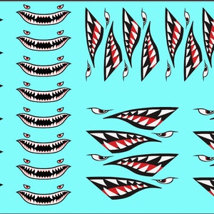 May include: A sheet of white vinyl decals with black and red shark teeth and eyes. The decals are in various sizes and shapes, including full mouth and single tooth designs.