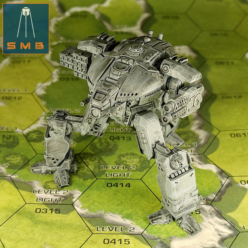 May include: A detailed, gray miniature war machine with multiple missile launchers and articulated legs stands on a hexagonal game board. The model has intricate mechanical details and is labeled with the text "SMB".