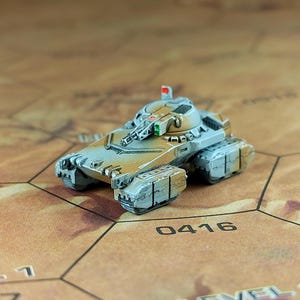 May include: A small, gray and brown, futuristic-looking tank with a raised gun turret and a red flag on top. The tank is sitting on a brown hexagonal game board with the number 0416 printed on it.