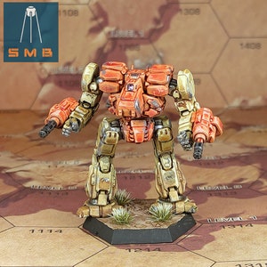 May include: A painted miniature of a battle mech, a robot with two large guns, standing on a black base. The mech is primarily orange and yellow with some brown and grey details. The mech is standing on a hexagonal tile with numbers printed on it.