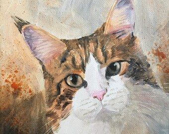 May include: A painting of a brown, white, and black tabby cat with green eyes. The cat is looking directly at the viewer. The background is a light brown with orange splatter paint.