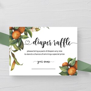 May include: A white card with a floral design featuring orange blossoms and green leaves. The text "diaper raffle" is written in black cursive font. The text "please bring a pack of diapers any size to stand a chance of winning a special prize" is written in black font. The text "your name" is written in black cursive font.