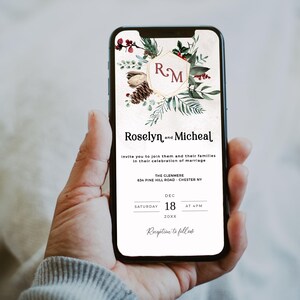 May include: A smartphone displays a wedding invitation with floral and pinecone accents. The invitation reads "Roselyn and Micheal" and includes the date, time, and location: The Glenmere, Chester NY. The invitation is held in a person's hand.
