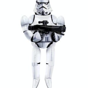 May include: A white Stormtrooper figure from Star Wars, holding a black blaster rifle. The figure has a detailed helmet and armor, with black accents. The toy is a collectible item.