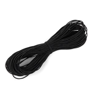 May include: A spool of black elastic cord, tightly wound and secured with a smaller piece of the same material. The cord is a solid black color and appears to be made of a flexible material. The background is plain white.