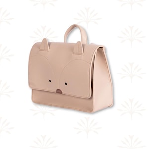 May include: A light tan backpack with a fox face design. The bag has a handle and two small ears at the top. The fox face is created with stitched details and small black dots for eyes. The bag has a rectangular shape.