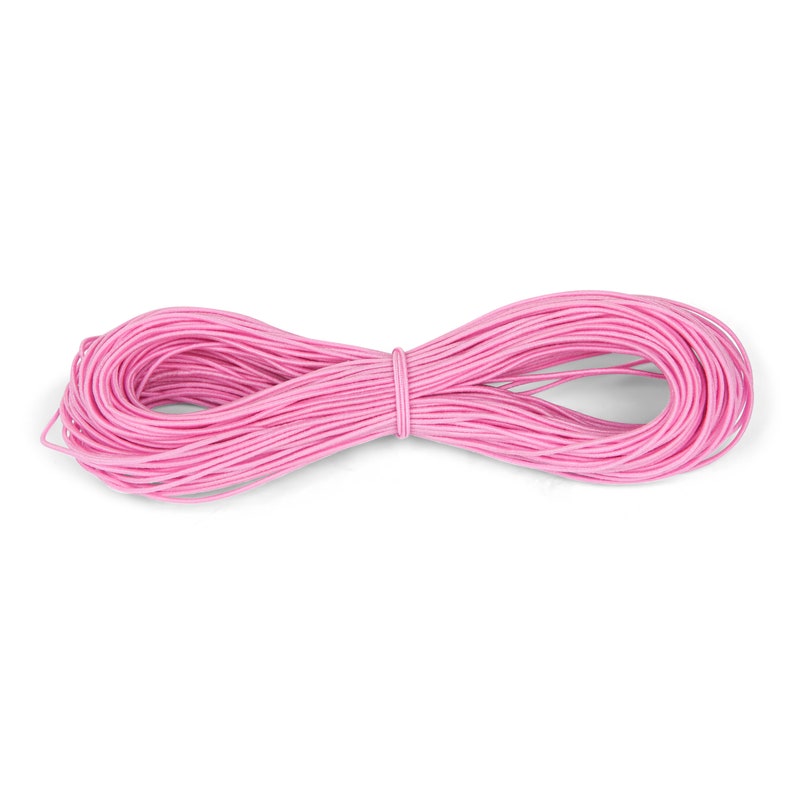 May include: A spool of pink elastic cord, perfect for crafting projects.
