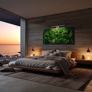 May include: A bedroom with a wooden bed frame and a large window overlooking a sunset over the ocean. The bed is made with white linens and has a green moss wall art above the headboard. There are two bedside tables with lamps.
