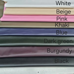 May include: A stack of eight leather swatches in different colors, from top to bottom: white, beige, pink, khaki, blue, dark green, burgundy, and black.