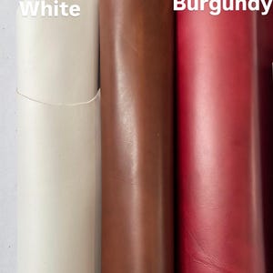 Puede incluir: Tres rollos de cuero en diferentes colores: blanco, marr&oacute;n y burdeos. El cuero est&aacute; enrollado y los extremos son visibles. Las palabras "Blanco", "Marr&oacute;n" y "Burdeos" est&aacute;n escritas en los rollos.
