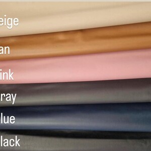 May include: A selection of leather swatches in various colors, including beige, tan, pink, gray, blue, and black. The names of the colors are printed on the image. The leather appears smooth and has a slight sheen.