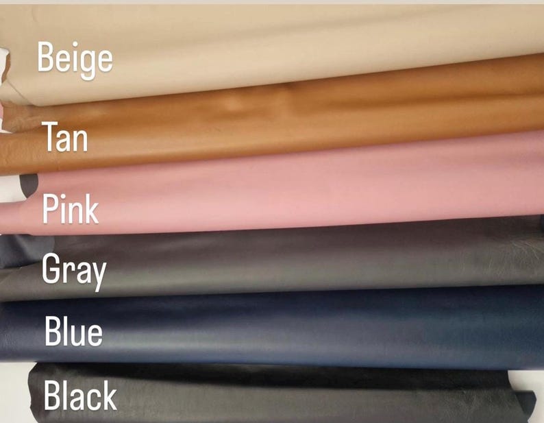 May include: A selection of leather swatches in various colors, including beige, tan, pink, gray, blue, and black. The names of the colors are printed on the image. The leather appears smooth and has a slight sheen.