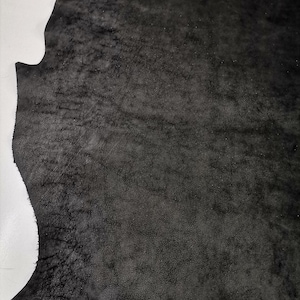 May include: A piece of black leather with a textured surface.