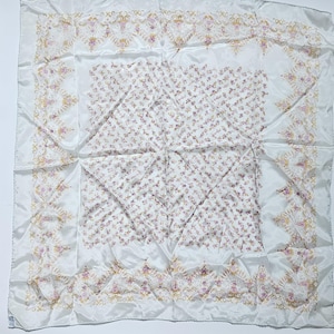 May include: White square scarf with a floral pattern. The scarf has a delicate design with small pink flowers and gold and pink decorative borders. The fabric appears to be silk or a similar smooth material.