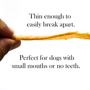 May include: A hand holds a thin, golden-brown dog treat that is easily broken apart. The text "Thin enough to easily break apart. Perfect for dogs with small mouths or no teeth." is below the treat.
