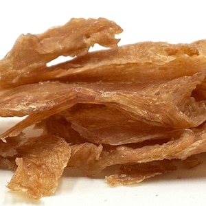 May include: A pile of thin, crispy, light brown chicken jerky strips.