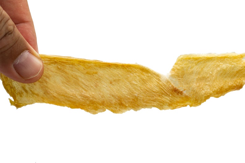May include: A thin, light brown, dried fish skin snack.