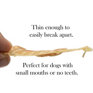 May include: A thin, light brown dog treat that is easily broken apart. The text "Thin enough to easily break apart. Perfect for dogs with small mouths or no teeth." is printed below the treat.