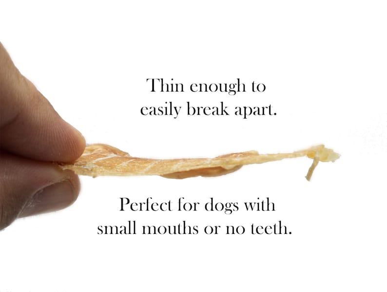 May include: A thin, light brown dog treat that is easily broken apart. The text "Thin enough to easily break apart. Perfect for dogs with small mouths or no teeth." is printed below the treat.