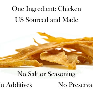 May include: A pile of thin, light brown chicken jerky strips. The text "One Ingredient: Chicken US Sourced and Made" is above the jerky. The text "No Salt or Seasoning No Additives No Preservatives" is below the jerky.