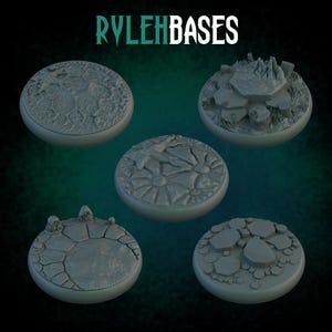 May include: Five gray, circular bases with textured surfaces. The bases feature various designs, including cracked earth, floral patterns, and rocky terrain. The text "RYLEH BASES" is displayed at the top of the image.