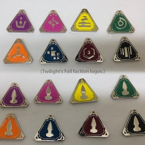 Könnte beinhalten: Eine Sammlung dreieckiger Metallnadeln mit verschiedenen farbenfrohen geometrischen Designs und einem silbernen Rand. Die Nadeln zeigen Symbole in Lila, Rosa, Gelb, Grün, Orange und Blau. Der Text unten lautet "(Twilight's Fall faction logos.)".