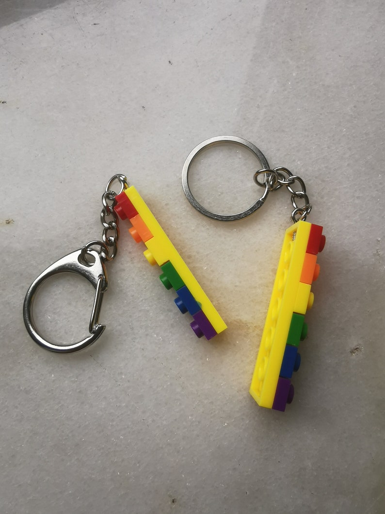 May include: A rainbow-colored keychain made of Lego bricks attached to a silver key ring.
