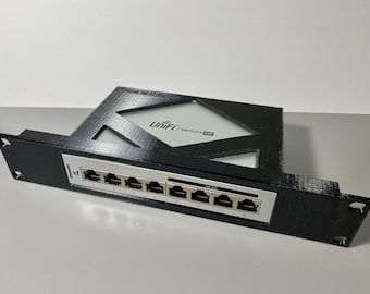 May include: A black plastic wall mount for a UniFi Switch 8 60W. The mount has a cutout for the switch and eight ethernet ports.