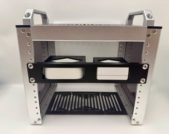 May include: A silver metal rack with a black shelf and a black slotted bottom. Two white rectangular objects are held in place by the black shelf. The rack has two silver handles on top and is secured with screws.