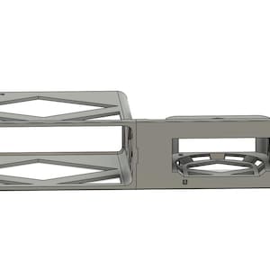 May include: A silver car console featuring a cup holder and storage compartments. The console has a geometric design with diamond-shaped cutouts and a textured surface. The word "FASTEN" is visible on the top.