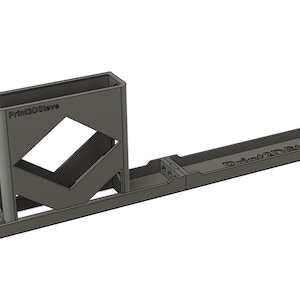 May include: A grey 3D printed storage organiser with the text "Print3Dstore" on the side. The organiser has a long, rectangular base and a vertical compartment with a geometric pattern.