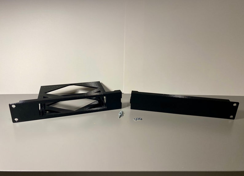 May include: Two black plastic pieces for a 3D printed rack, with two screws and two washers.