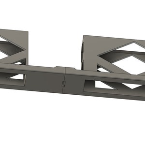 May include: A metal rack with two open compartments, each with a diamond-shaped cutout pattern. The rack is designed to hold two devices, with a slot for each device in the center of the rack.