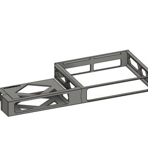 May include: A gray, geometric metal structure with an open rectangular frame and a smaller, attached section. The design features cut-out shapes and a sturdy, industrial aesthetic. The object is set against a plain white background.