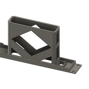 May include: A grey, 3D-printed object with a rectangular base and a vertical, open-topped compartment. The design includes a diamond-shaped cutout and a smaller square feature. The object appears to be a holder or stand.