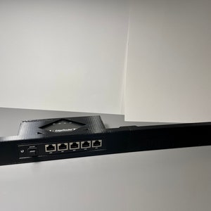May include: Black plastic rack with six ethernet ports and a power switch. The rack is labeled "EdgeRouter X".