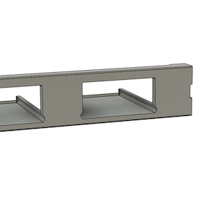 May include: A gray metal plate with three rectangular cutouts. The plate has two small holes on the left side.