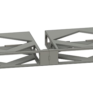 May include: A gray metal rack with a geometric design. The rack is designed to hold two items, such as electronics or other equipment. The rack has a rectangular shape and is made of metal.