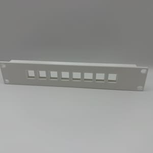 May include: A white rectangular panel with eight square openings, likely for network cables. The panel has rounded corners and two mounting holes. The item is made of plastic and is designed for mounting in a rack.