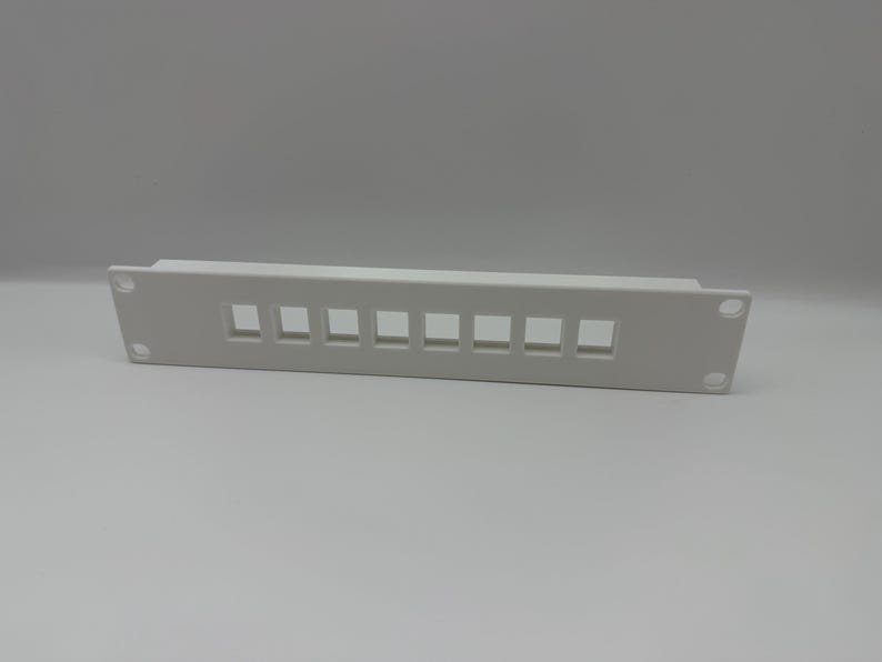 May include: A white rectangular panel with eight square openings, likely for network cables. The panel has rounded corners and two mounting holes. The item is made of plastic and is designed for mounting in a rack.