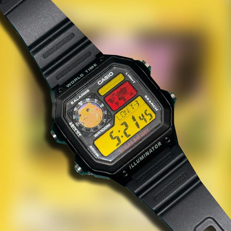 May include: Black Casio digital watch with a yellow and black display. The watch face shows the time, date, and other functions. The watch has a black band and is water-resistant. The watch face also has the text "CASIO" and "ILLUMINATOR".