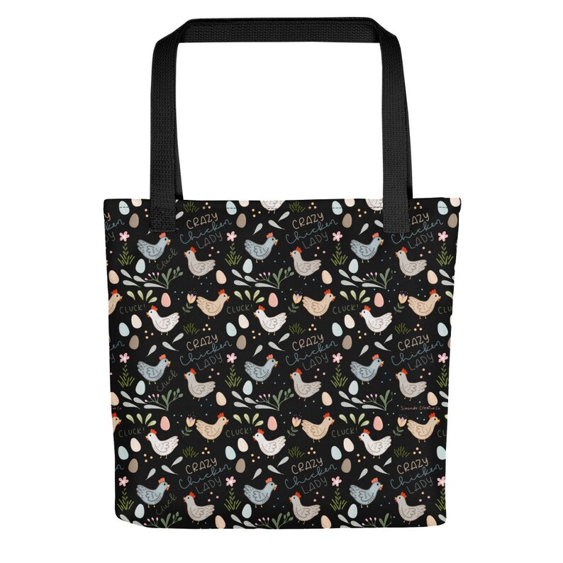 May include: Black tote bag featuring a repeating pattern of colourful chickens, eggs, and flowers. The text "Crazy Chicken Lady" is repeated throughout the pattern.