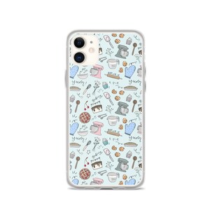 May include: A clear phone case with a light blue background and a pattern of baking-themed illustrations. The illustrations include a mixer, a rolling pin, a pie, a cupcake, a cherry, a spoon, a whisk, and the words "yum!" and "baking time".