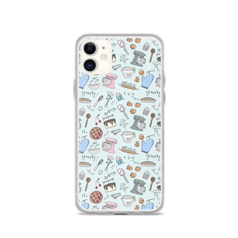 May include: A clear phone case with a light blue background and a pattern of baking-themed illustrations. The illustrations include a mixer, a rolling pin, a pie, a cupcake, a cherry, a spoon, a whisk, and the words "yum!" and "baking time".