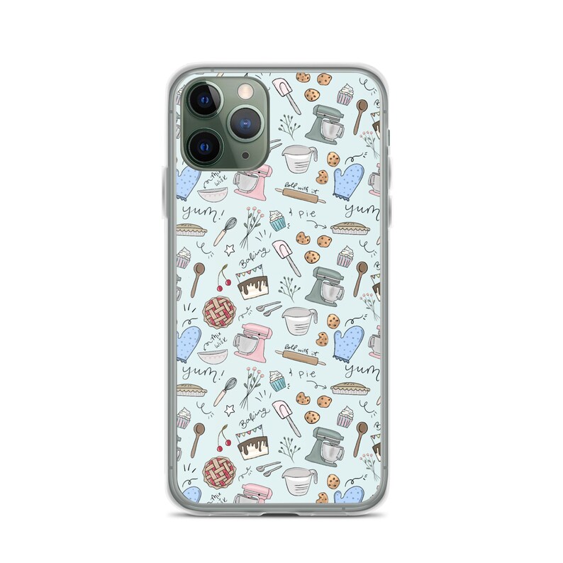 May include: A clear phone case with a light blue background and a pattern of baking-themed illustrations. The illustrations include a mixer, pie, cookies, cherries, and the words "yum!" and "baking".