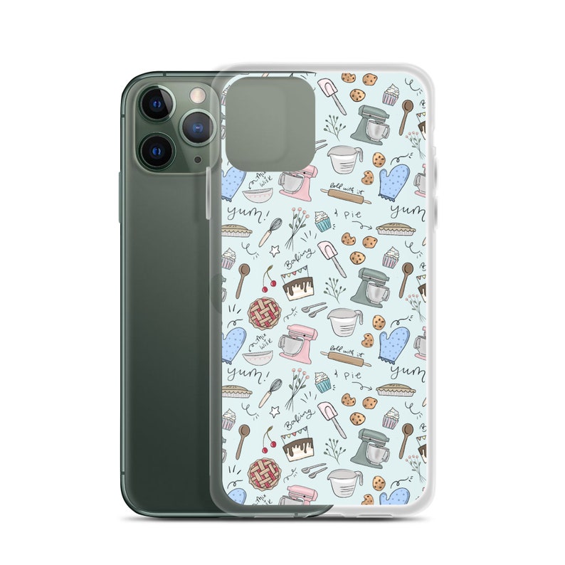 May include: A clear phone case with a light blue background and a pattern of baking-themed illustrations. The illustrations include a mixer, a pie, a cupcake, a rolling pin, a spoon, a cherry, a cake, and the word "yum!" in a handwritten font.