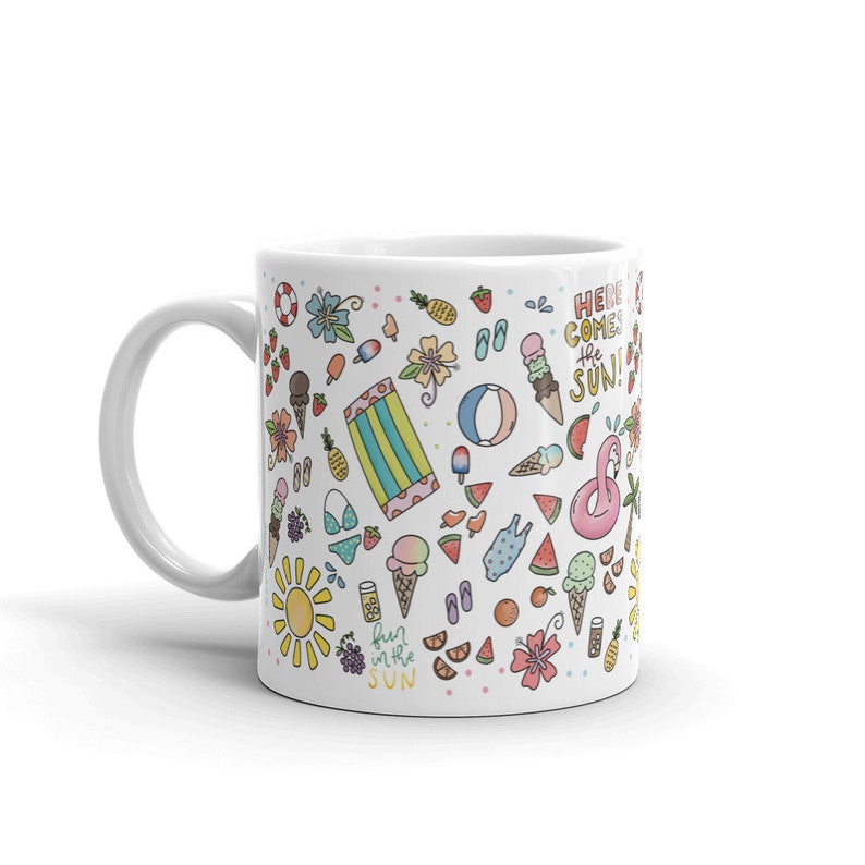 May include: White ceramic mug with a colorful summer-themed design. The design features various summer icons such as ice cream cones, watermelon slices, flip flops, pineapples, and a beach towel. The text "Here comes the sun!" and "Fun in the sun" are also included in the design.