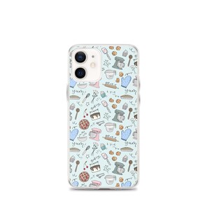 May include: A clear phone case with a light blue background and a pattern of baking-themed illustrations. The illustrations include a mixer, a pie, a cupcake, a whisk, a rolling pin, a spoon, a measuring cup, a cookie, a cherry, a cake, and the words "yum!" and "baking".